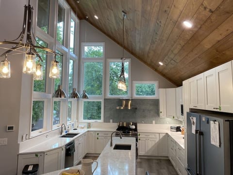 Chef's kitchen with multiple refrigerators and natural gas stove. Lake views.