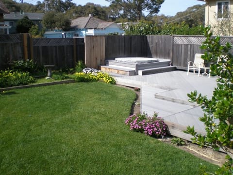 Fenced in Backyard with Hot Tub and Fire Pit.