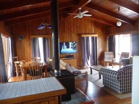 Open plan lounge, dinning and kitchen with cathedral ceiling and timber lined.