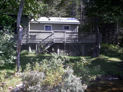 Cottage with gently sloping lawn leads to private beach area & easy access to crystal clear lake