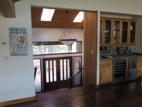 Front entry and adjacent wet bar with sink, wine chiller and beverage cooler.