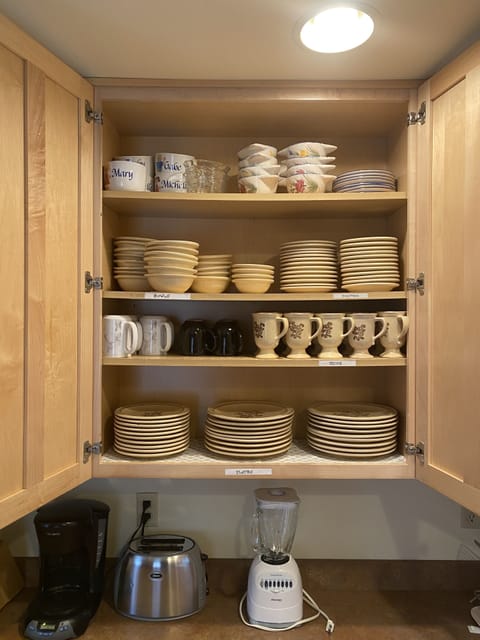 Plenty of dishes, glasses, silverware, pots and pans.