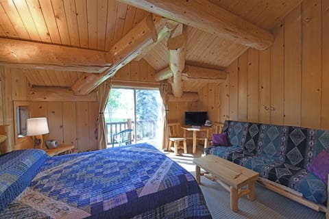The studio is the upper floor of the log townhome.