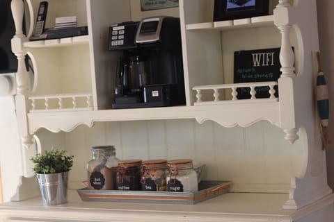 Fully stocked coffee bar with k-cups and coffee grounds.