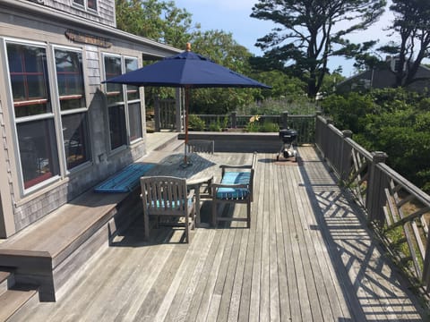 Large deck with teak dining set, umbrella and awesome views over Quidnet
