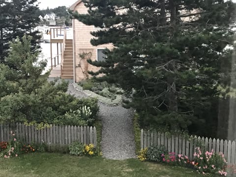 Park, go up stairs to the left, into sliding glass door on deck 