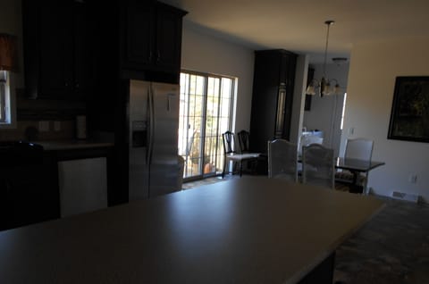 Dark view of the dining room from the living room.  Sliding glass doors to deck
