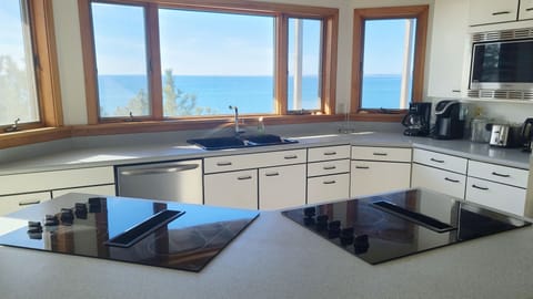 Kitchen has two cooktops and a wall oven