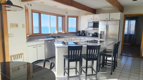 Nicely equipped kitchen with counter seating and water views