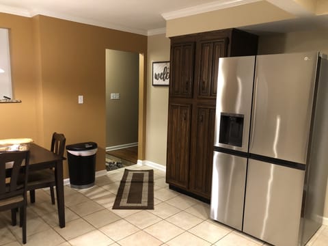 Front entry leading to kitchen and living room w/ wet bar.
