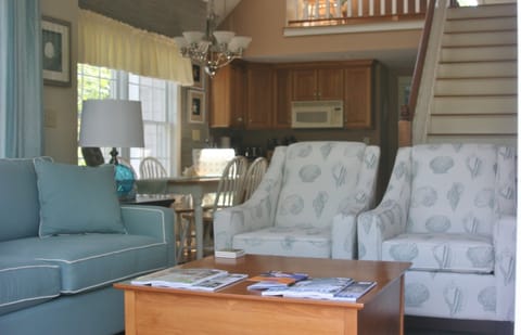 Comfortable living room with amply seating that opens to the outside deck.