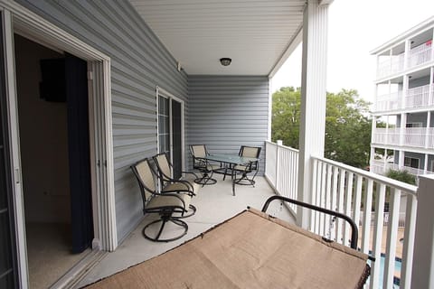 Top balcony has a table chairs and hammock