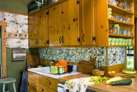 counter and sink with broken dish mosaic backsplash