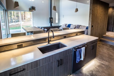 The well-lit contemporary kitchen makes it fun to fix up a meal or cocktail