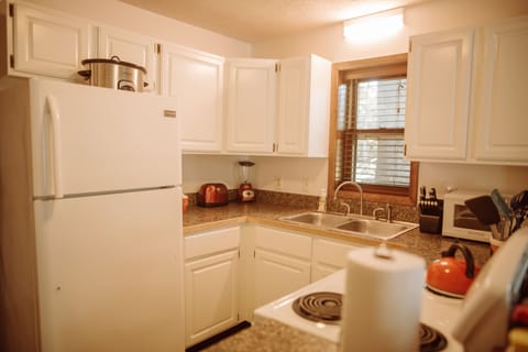 Kitchen is set with all appliances, cookware, and dishes you might need