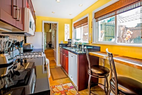 Sunny kitchen has breakfast bar seating.