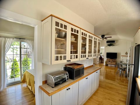 Full galley kitchen with all cooking essentials and dinnerware.