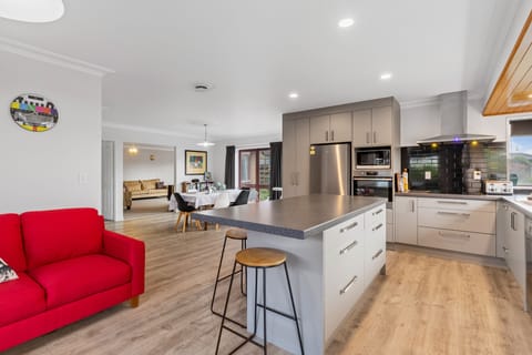 Open plan kitchen, family, dining, peeking into the lounge.