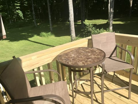 Back patio overlooking the firepit and yard.