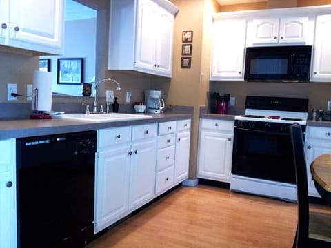 The kitchen has plenty of storage space and overlooks the living room.