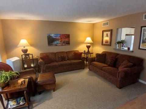 Living Room ofers a large double window overlooking the woods and hillside.