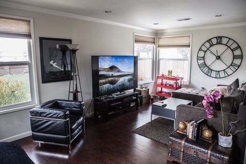 Living room with sectional, arm chair and chaise lounge. Surround sound & 72” TV