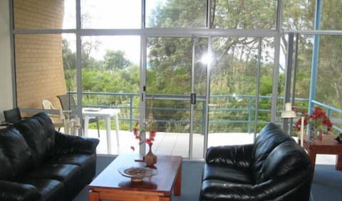 Spacious living area, with high ceiling, opening to one of three balconies.
