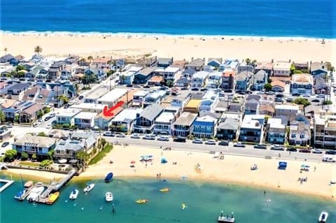 Aerial view of the property and location. Across from sandy bay front beach