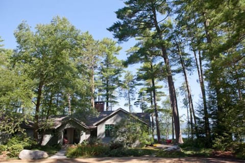 View of the front entrance with Squam Lake behind the house.