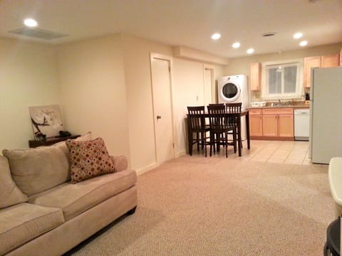 Living room looking into dining room and kitchen. In unit washer and dryer