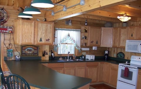 Large, well-equiped kitchen has eat-in counter.