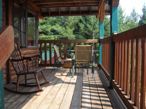 Front porch overlooks the pine woods below.