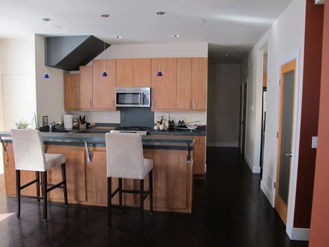 Designer kitchen w/concrete counters, dining bar, Jenn-Air stainless appliances