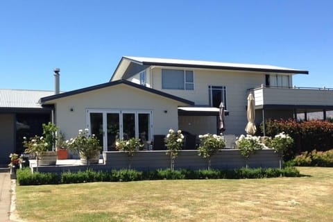 Frontage Rata Street with large deck and outdoor table and chairs 