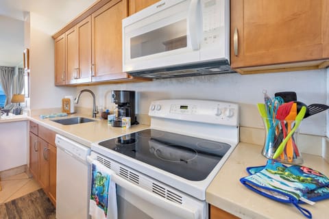 Kitchen with stove, oven, microwave, and sink