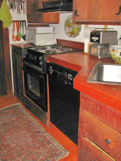 Galley kitchen with antique barn board cabinets