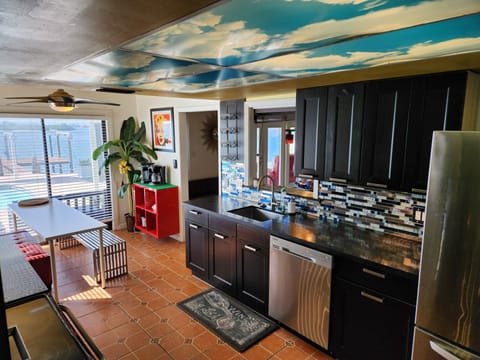 The kitchen offers dining with bench seating and stunning pool and water views.
