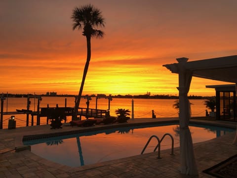 Experience paradise with a dip in the pool as the sun sets in a blaze of glory.