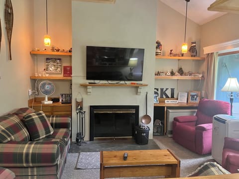 Living Room - couch, loveseat, 2 recliners, flatscreen TV over fireplace. 