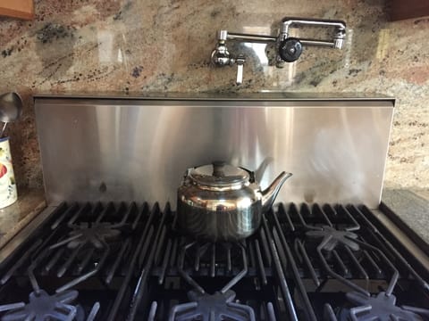 6 burner Thermador gas range and a convenient pot filler faucet