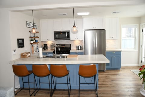 Kitchen with stove, microwave, fridge, dishwasher, toaster, and coffee maker.