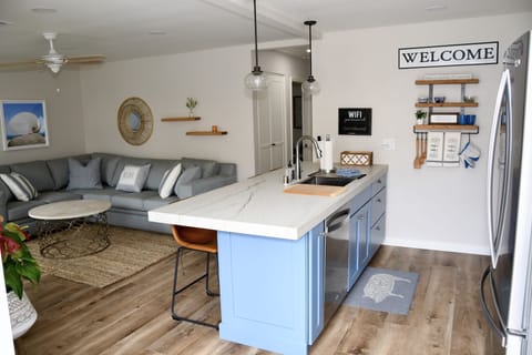 Kitchen counter with bar area with 4 bar stools.  