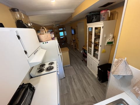 Small electric stove, toaster oven, microwave, Kerig, Mr. Coffee and fridge.