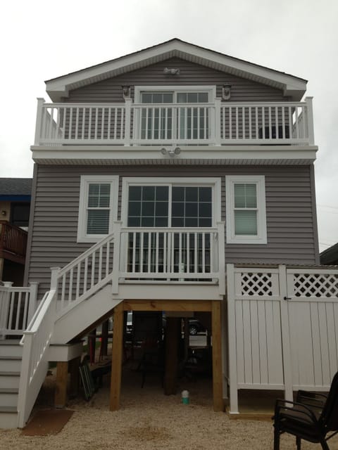 Back of house.  ping pong under house for rainy days Balcony off master bedroom 
