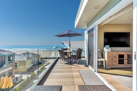 3rd level: Balcony off Living room with lounge chairs and dining for 4 people