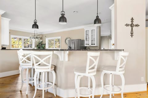 Enjoy casual meals and conversation at the bar seating in this stylish kitchen.