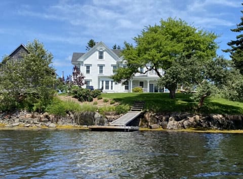 View of the house, backyard and private dock taken from the water