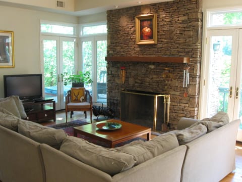 Cozy conversational area, classic stone fireplace, hot tub on deck, huge porch