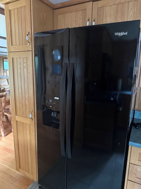 New Whirlpool refrigerator/ freezer with ice maker.