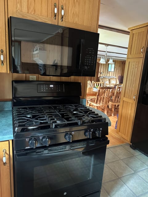 New 5 burner gas range with griddle and air frier and new microwave oven.